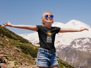 BIG DAY® Kids T-shirt Collection - smiling girl with arms held wide open while wearing BIG DAY Elevate Your Day black t-shirt