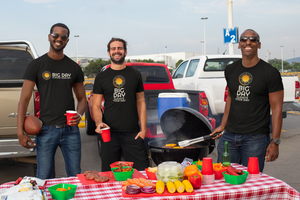 BIG DAY® Men's Apparel & Accessories Collection - group of men tailgating while wearing BIG DAY Elevate Your Day black t-shirts