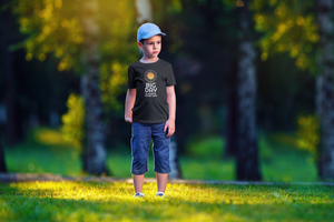 Kids BIG DAY® T-shirt Collection - Boy standing on grass wearing BIG DAY Elevate Your Day black t-shirt