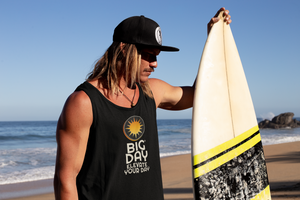 BIG DAY® Men's Tank Tops - man on beach with surf board wearing BIG DAY Elevate Your Day black tank top