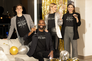 BIG DAY® New Year Holiday Collection - group of friends gathered together celebrating the New Year holiday while wearing New Year BIG DAY black t-shirts