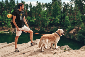 BIG DAY Men's T-Shirts - Man on rocky ledge with dog wearing BIG DAY Elevate Your Day black t-shirt