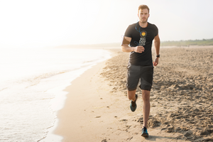 BIG DAY® Men's T-Shirts - Man running on beach while wearing BIG DAY Elevate Your Day black t-shirt